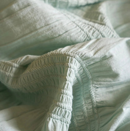 Detailed macro shot of the ruched texture on the Mint Green washed cotton fabric.