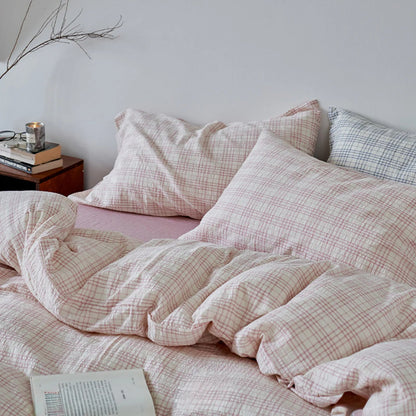 Angled view of the Dusty Pink Plaid Washed Cotton Bedding Set, highlighting its cozy and soft appearance - RoomDen