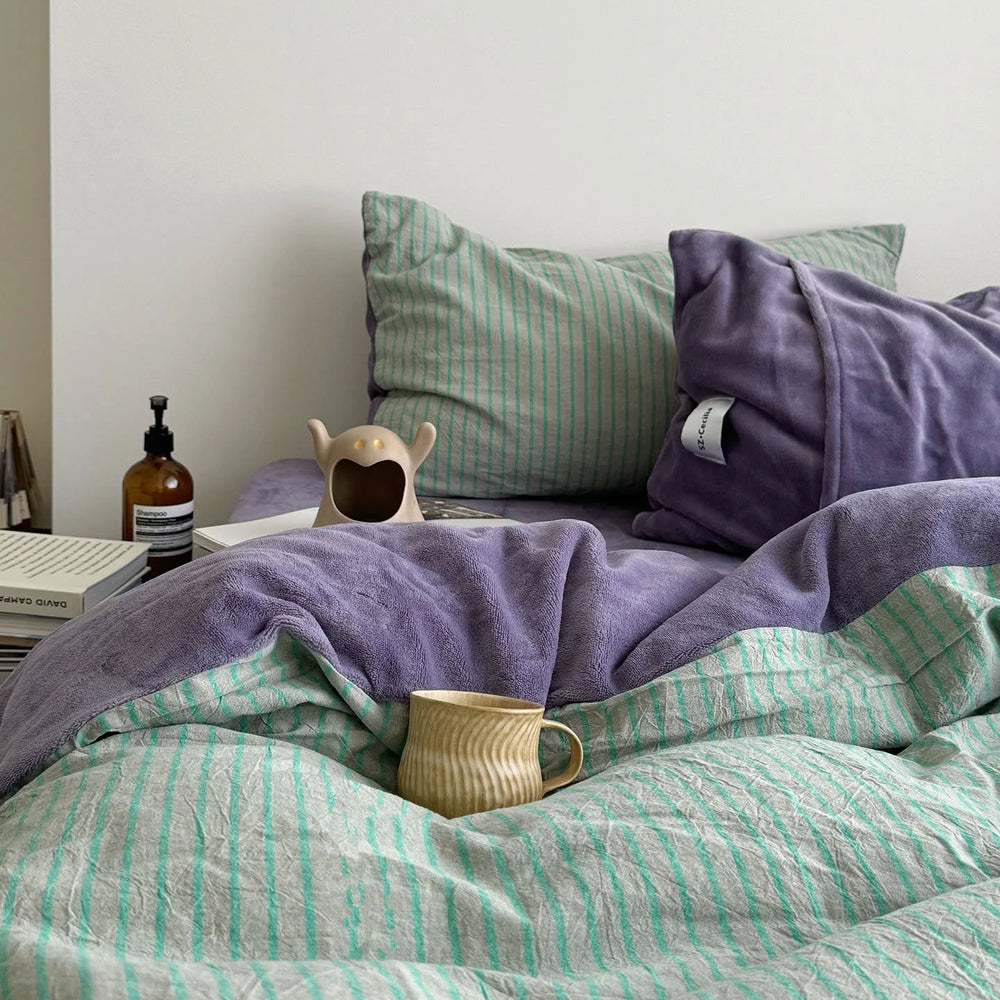 Plush Reversible Striped Flannel Fleece Bedding Set in Purple & Mint on a neatly made bed - RoomDen