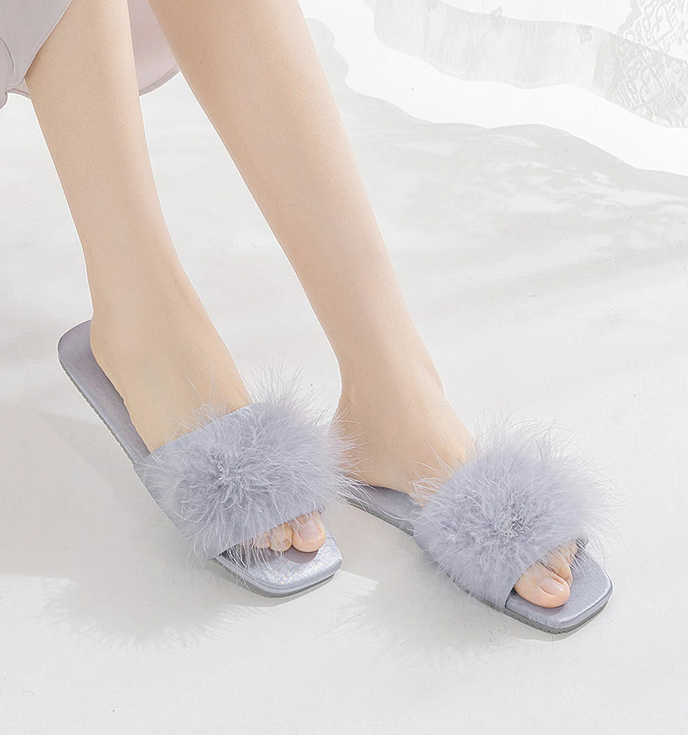 Lavender fluffy faux fur house slippers worn by model - RoomDen