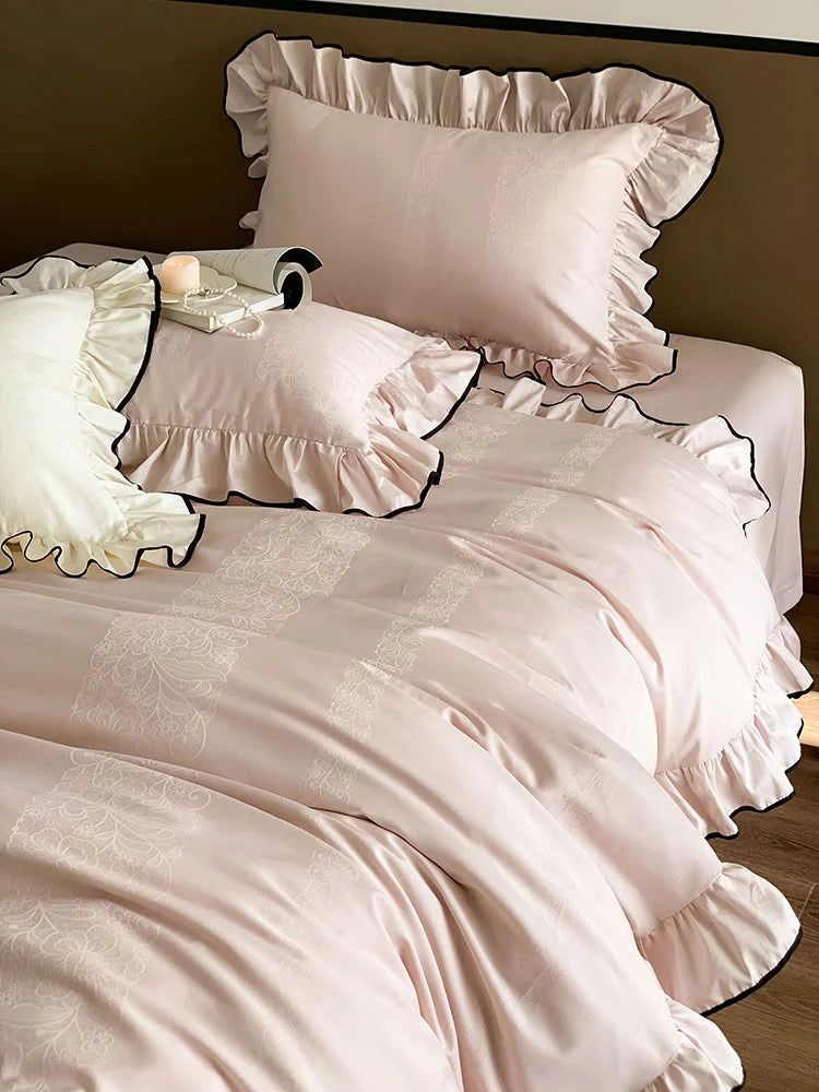 Full view of the Blush Pink & Black Trim ruffled jacquard Tencel bedding set on a bed - RoomDen.
