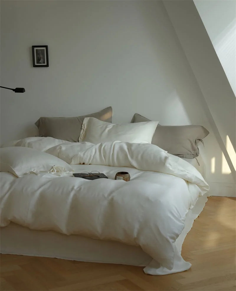 Silky Soft Tie Closure Tencel Bedding Set in Creamy White in a sunlit, minimalist attic bedroom - RoomDen