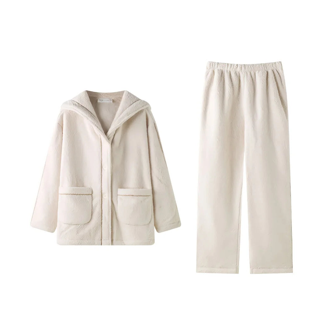Flat lay of the creamy white flannel fleece pajama set, showing the hooded button-up top and wide-leg pants - RoomDen.