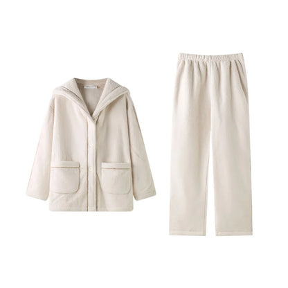 Flat lay of the creamy white flannel fleece pajama set, showing the hooded button-up top and wide-leg pants - RoomDen.