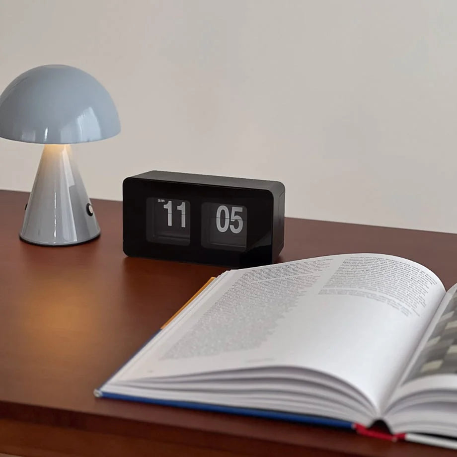 The all-black version of the retro flip clock sitting on a study desk. - RoomDen