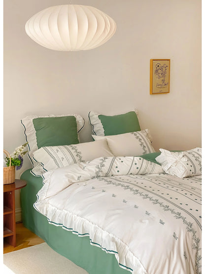 Full view of the Forest Green embroidered bedding set, highlighting the contrast of green and white.