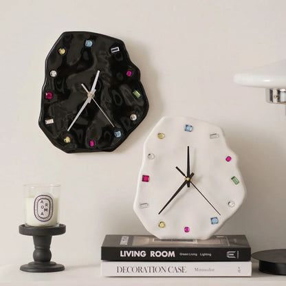 Wavy Jeweled Ceramic Clocks in black and white displayed on a shelf with books and a candle - RoomDen