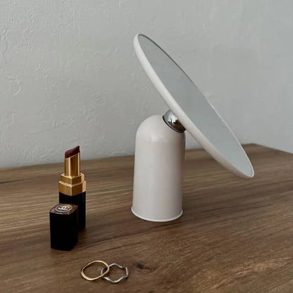 Close-up of the white rotating desktop mirror showing the 360-degree swivel joint.