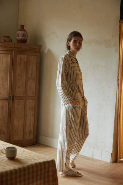 Side Profile of Woman Wearing Beige Whimsical Striped Pajamas - RoomDen