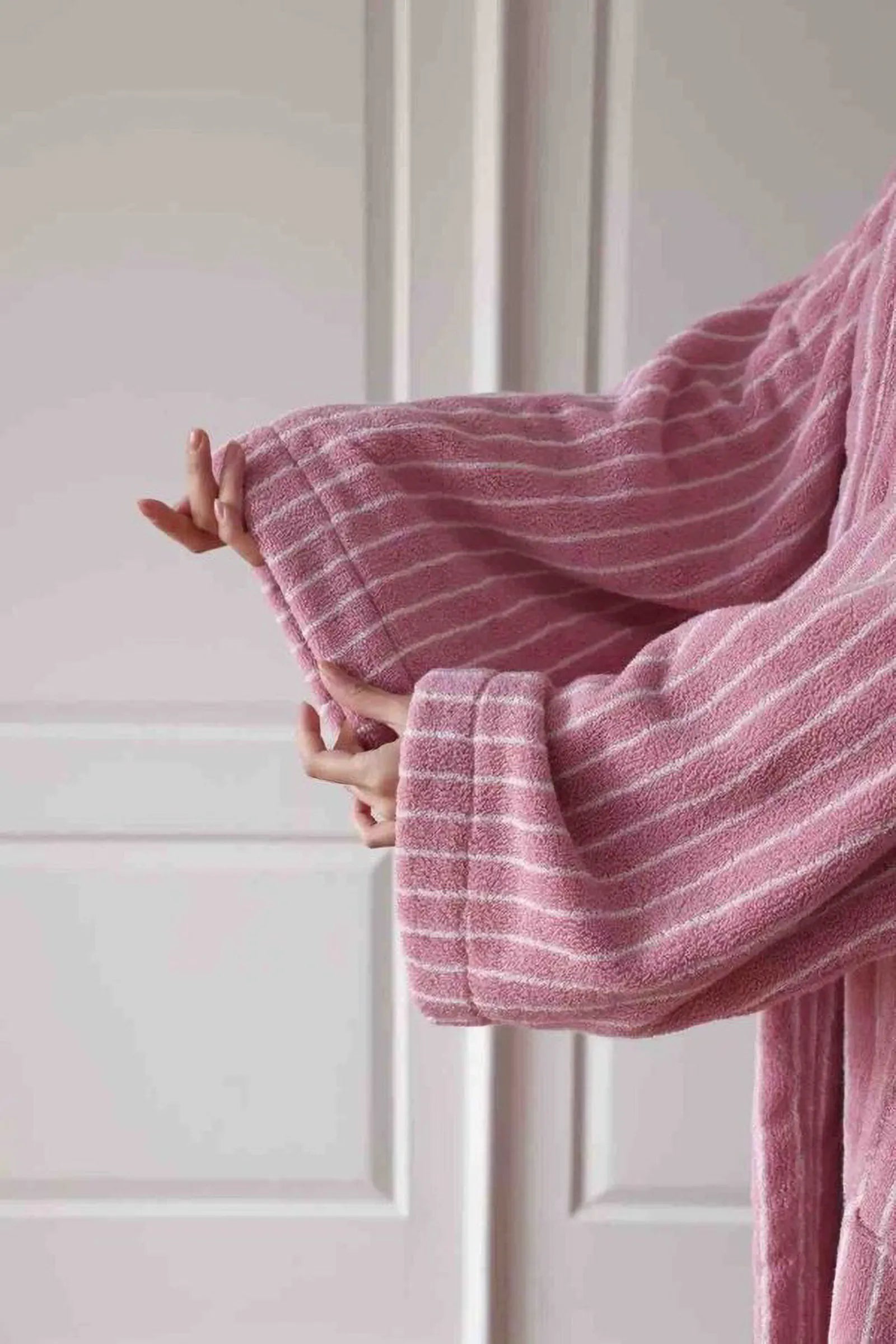 Close-up of the wide sleeve cuff texture on the pink striped long-staple cotton robe - RoomDen