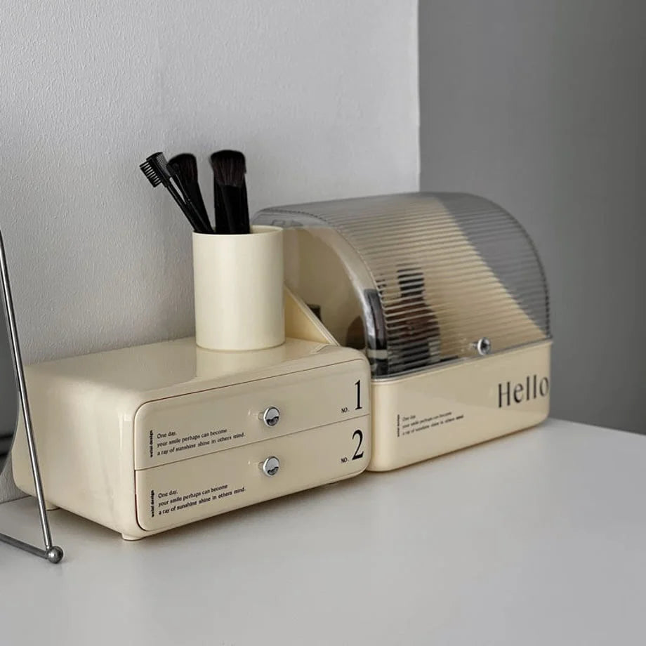 Angled lifestyle shot of the two-piece makeup organizer next to a brush holder on a desk.