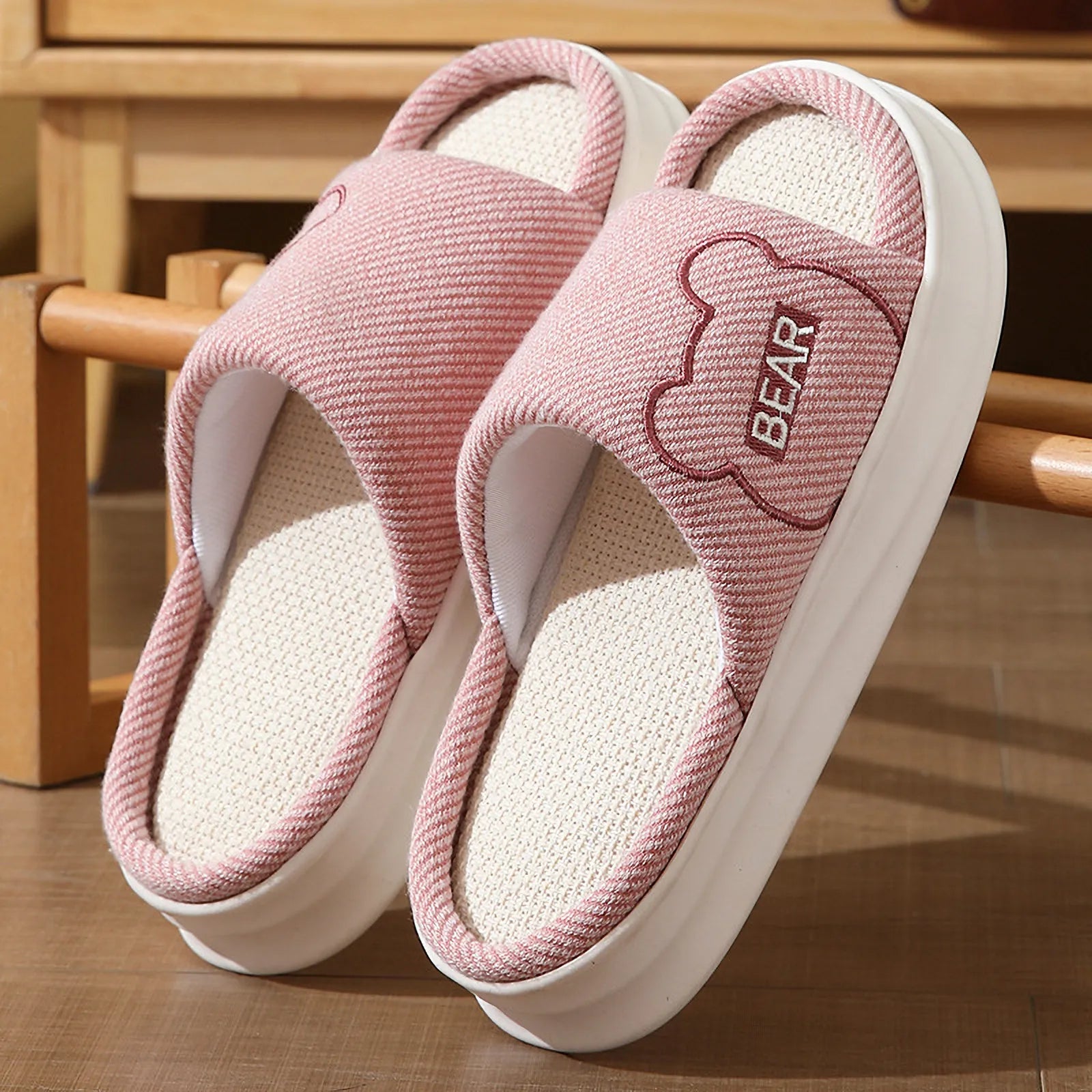 Detailed view of Pink platform linen slippers with brown bear embroidery