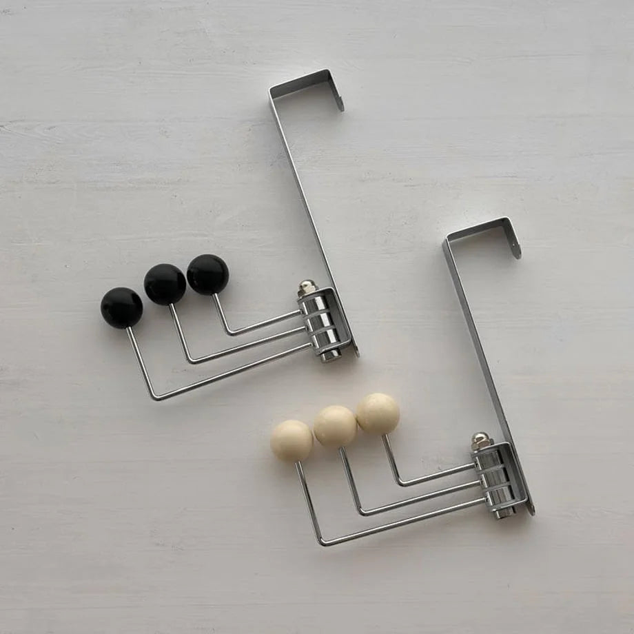 Top-down view showing both the black and beige variants of the Smooth Ball Tip Metal Over-the-Door Hook side-by-side - RoomDen