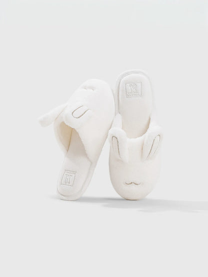 Side view of blue bunny slippers showing plush texture - RoomDen