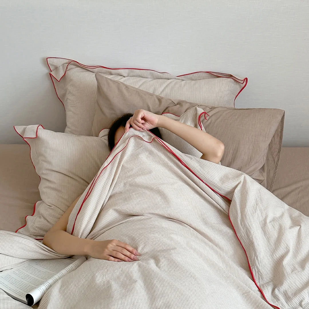 A person hiding under the cozy Beige & Red Pinstripe Washed Cotton Duvet Cover.