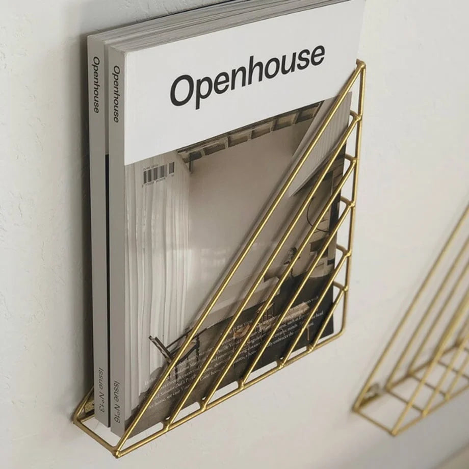 Detailed shot of the corner and wire construction of the gold magazine display - RoomDen