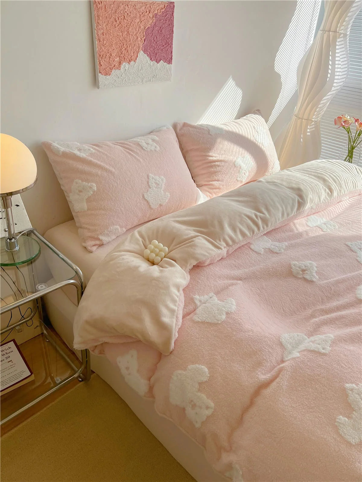 The blush pink teddy bear bedding set on a bed, showing the duvet cover and matching pillowcases in a sunlit room. - RoomDen