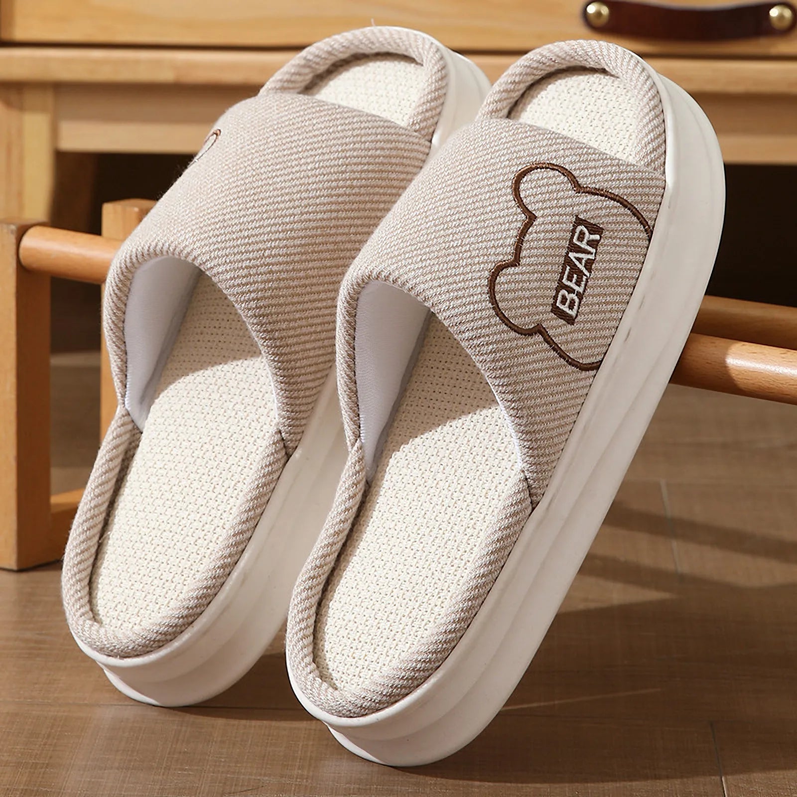 Detailed view of Beige woven texture slippers with bear design