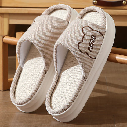 Detailed view of Beige woven texture slippers with bear design