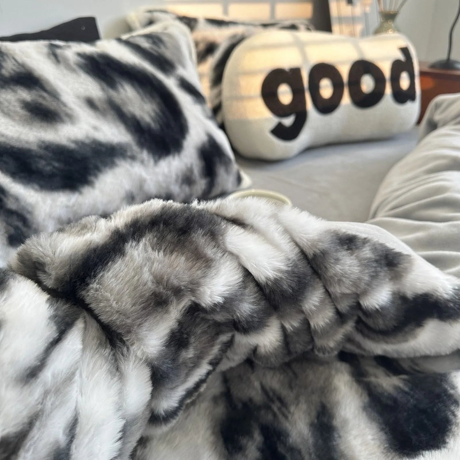 Detailed close-up of the abstract patterned fleece bedding, with the "good" pillow blurred in the background. - RoomDen