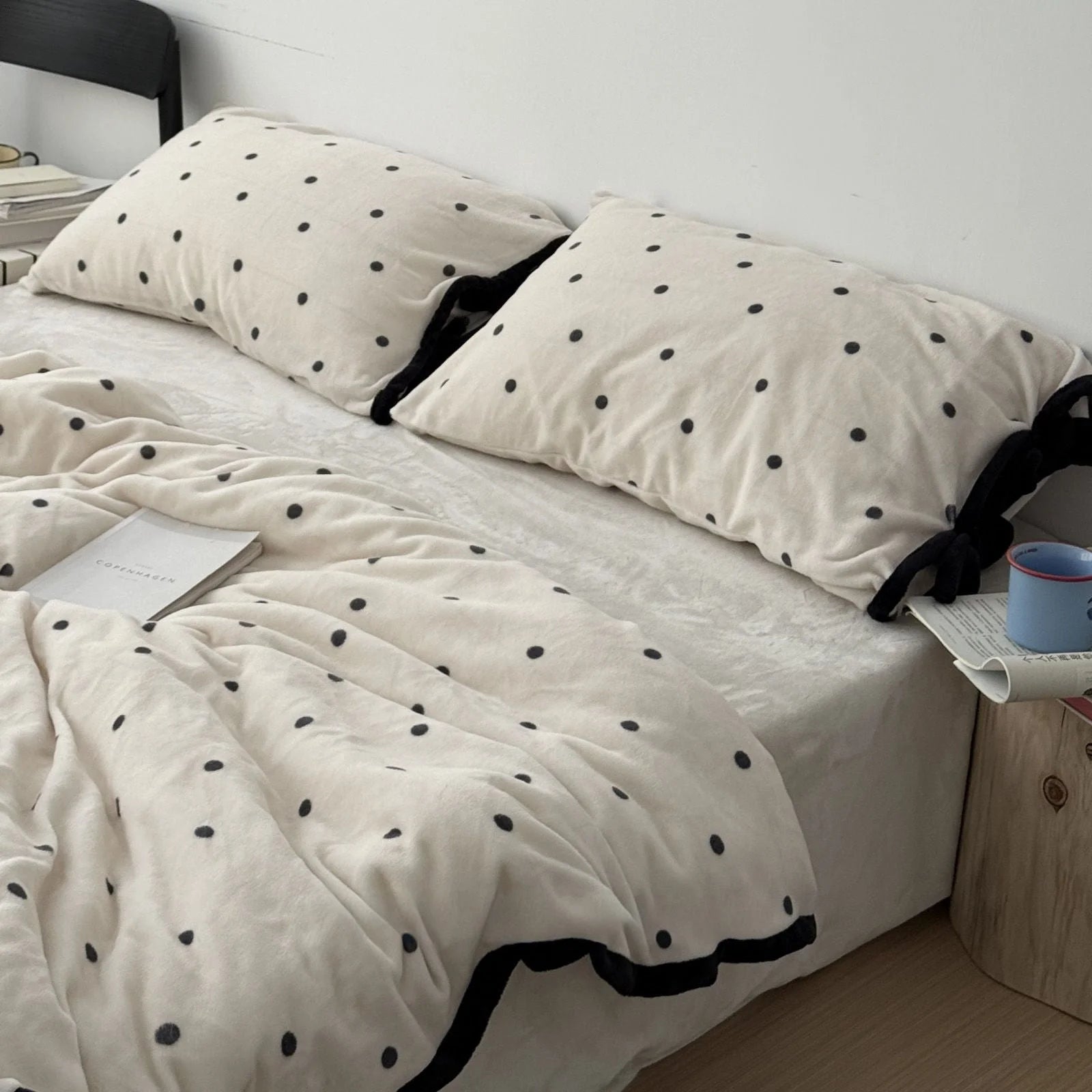 Angled view of the Creamy White Polka Dot Flannel Fleece Bedding Set, highlighting its soft and inviting texture.