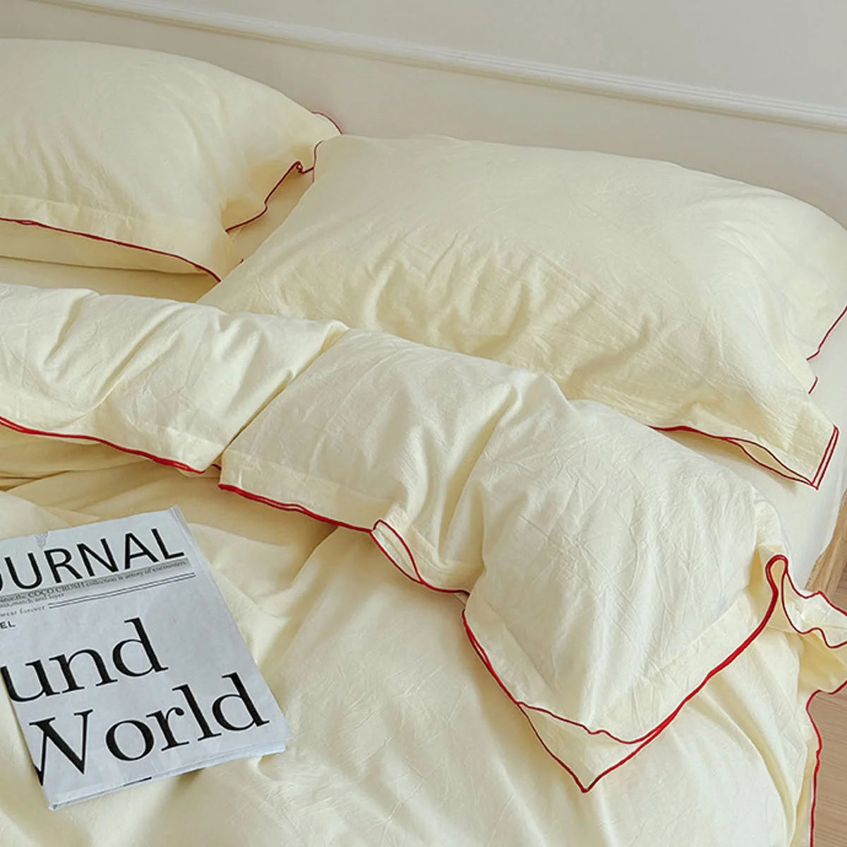 The buttercream ruffle trim duvet cover is artfully rumpled, showing its soft, lived-in texture. - RoomDen
