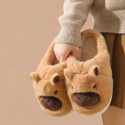 Brown Capybara plush house slippers held in hand RoomDen