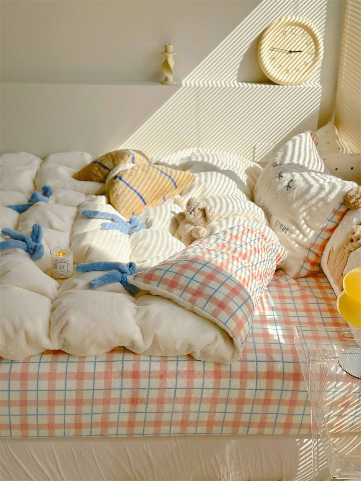 Side view of the Creamy White Bear bedding set in a brightly lit room with a clock on the wall.