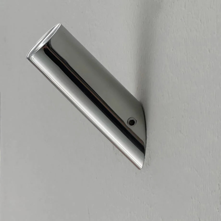 Top-down view of the sleek metal wall hook showcasing its reflective surface and minimalist form. - RoomDen