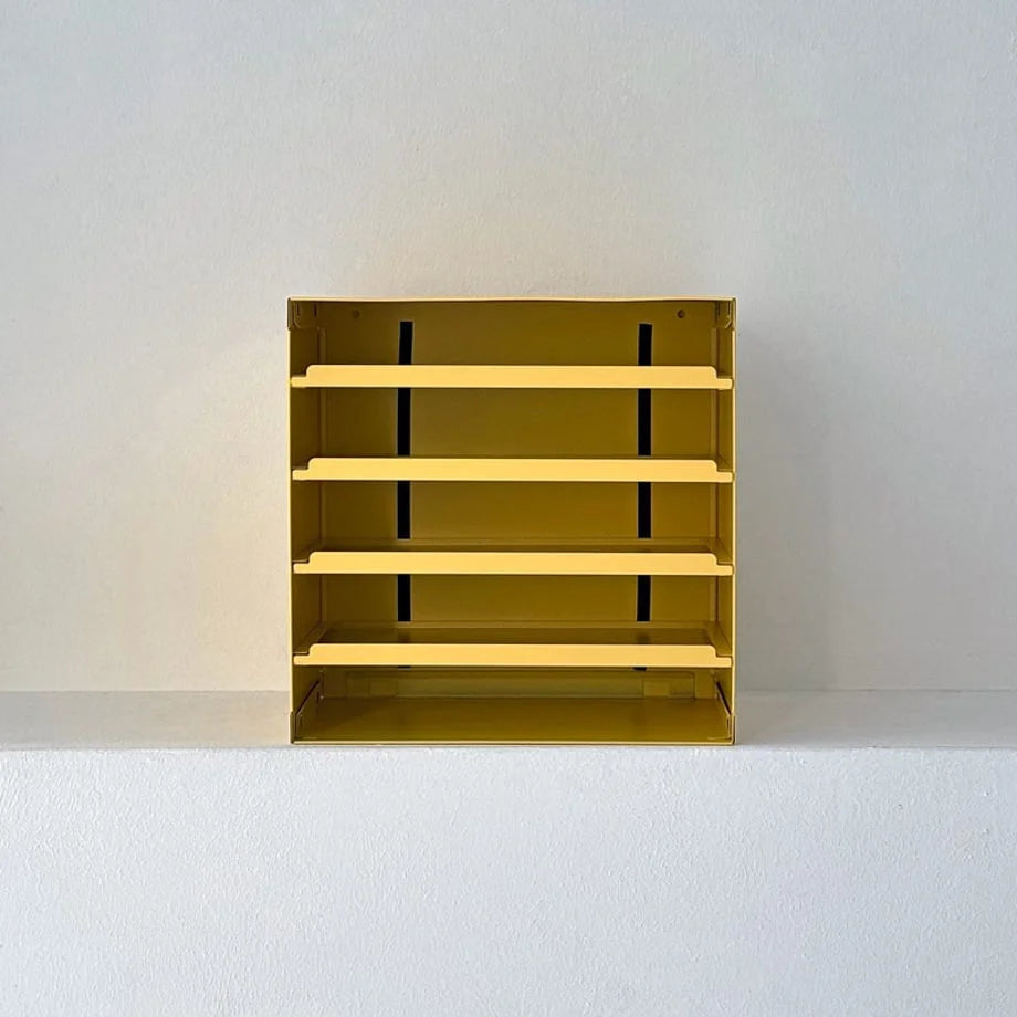 Direct front view of the empty Sunny Yellow metal desktop organizer against a white wall - RoomDen.