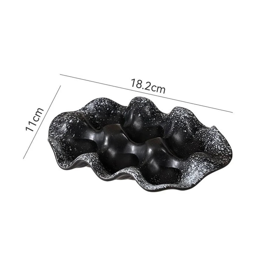 Black Speckled Wavy Ceramic Jewelry Dish with dimensions shown: 18.2cm by 11cm.