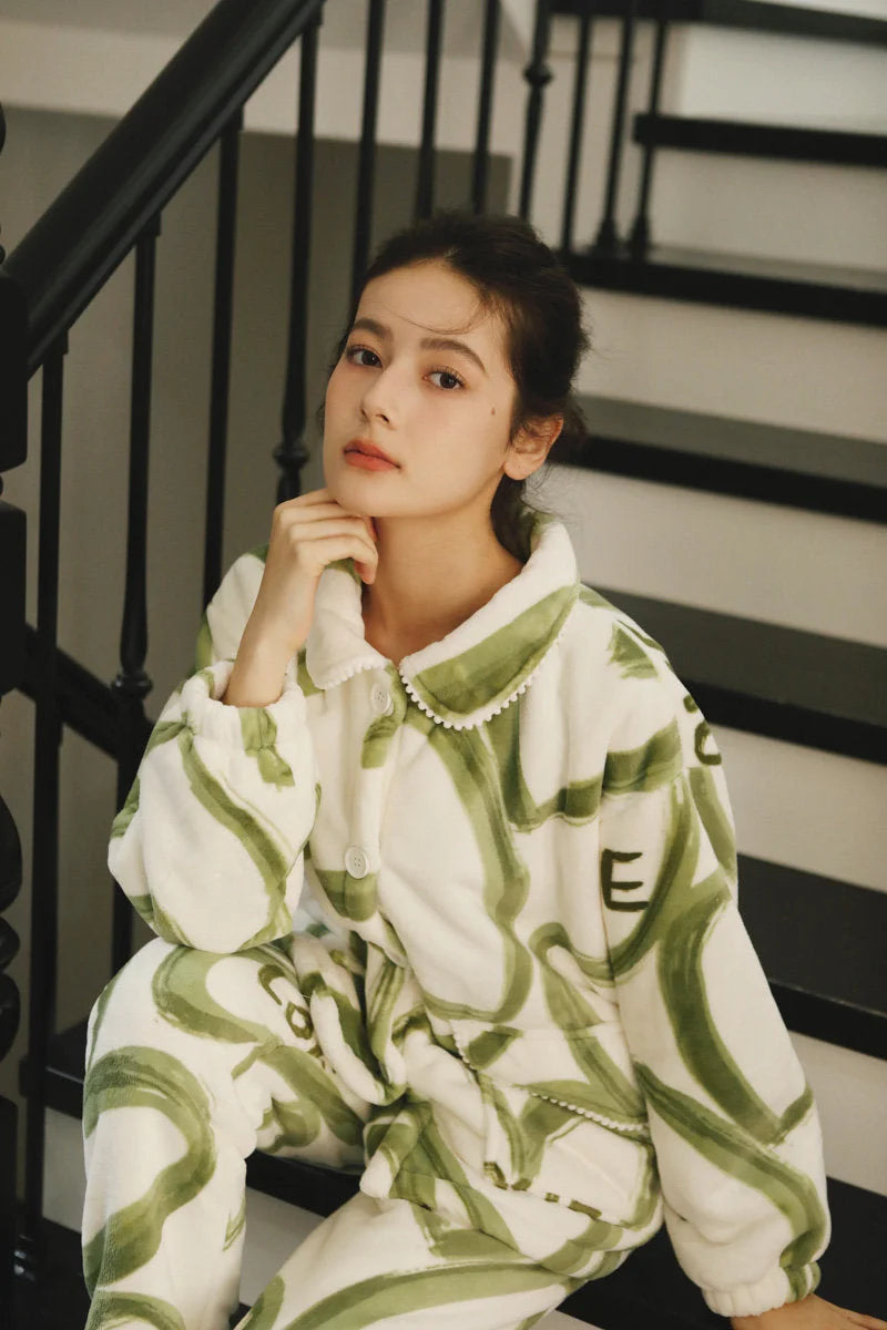 Close-up of the model's thoughtful expression while wearing the cozy graffiti print pajama set - RoomDen.