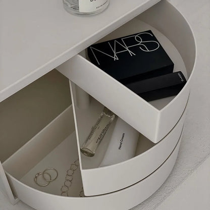 Close-up of the open drawers filled with makeup, jewelry, and hand cream. - RoomDen