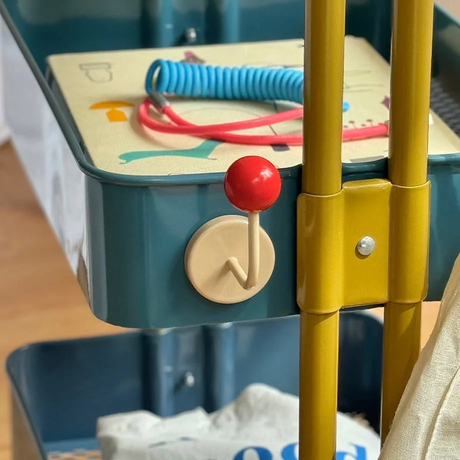 Detailed view of the Red & Beige Metal Hook on the side of a teal storage cart tier - RoomDen.