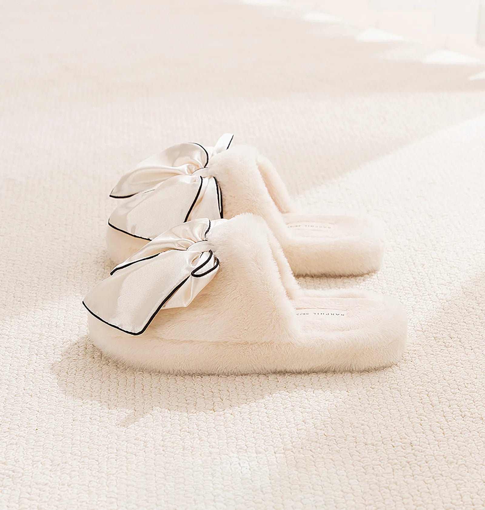 Side view of Cream Faux Fur Slides showing soft texture and bow detail