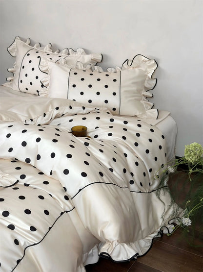 Detail shot of the duvet cover and pillows of the Creamy White & Black Polka Dot set, highlighting the Tencel fabric - RoomDen.