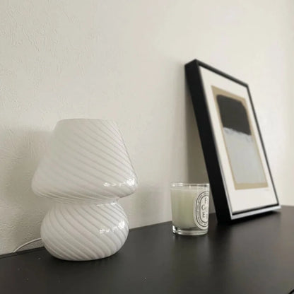 Side view of the unlit white Swirled Glass Mushroom Lamp, emphasizing its sculptural form.