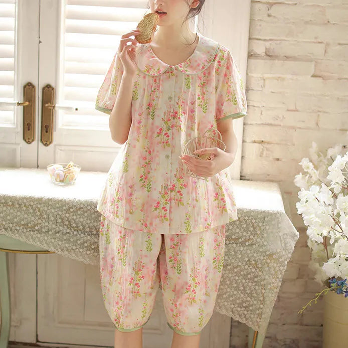 Girl standing eating toast wearing soft pink floral puff sleeve pajama set side view - RoomDen