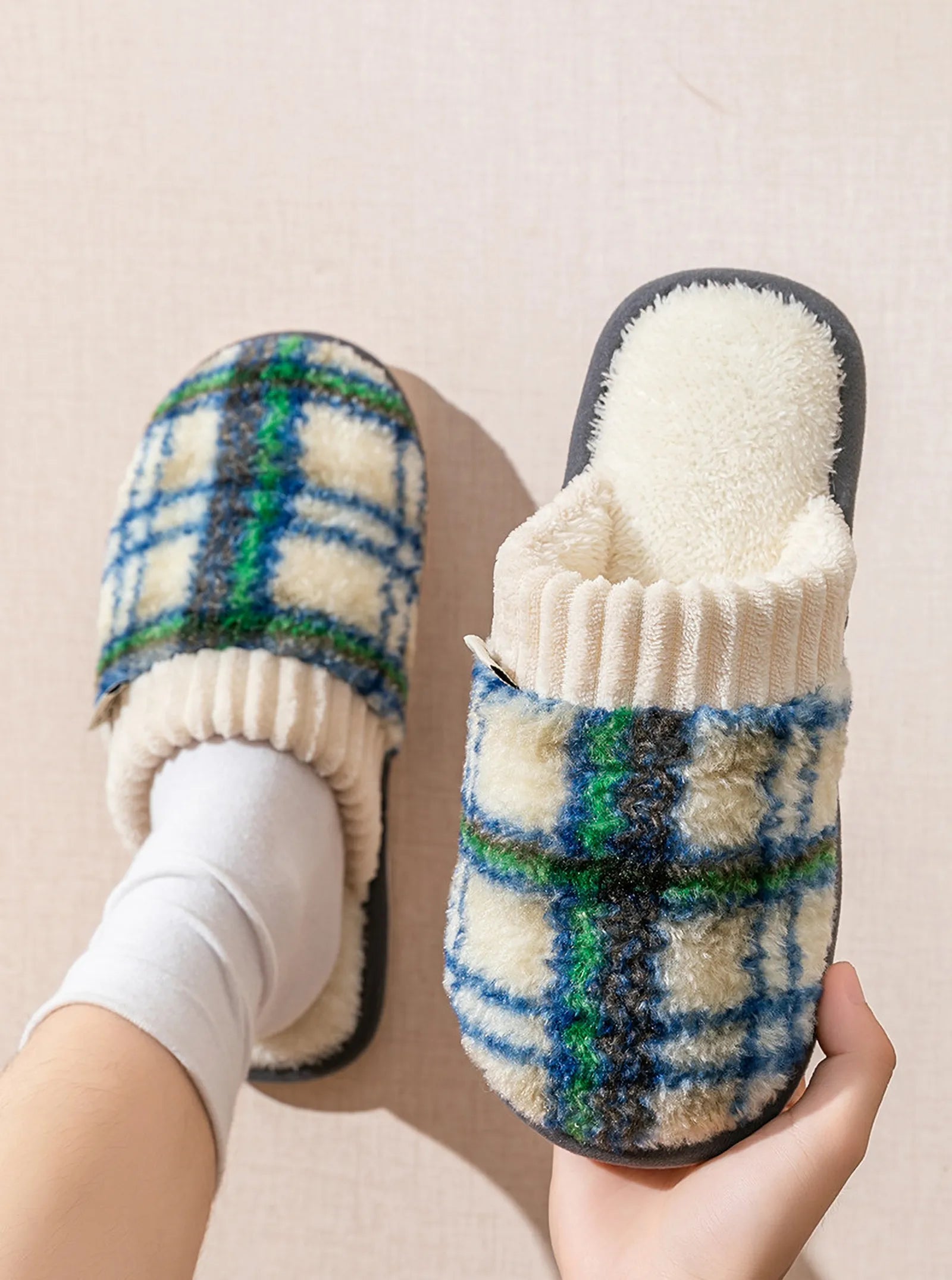 Model wearing green and blue plaid fuzzy house slippers with white socks - RoomDen