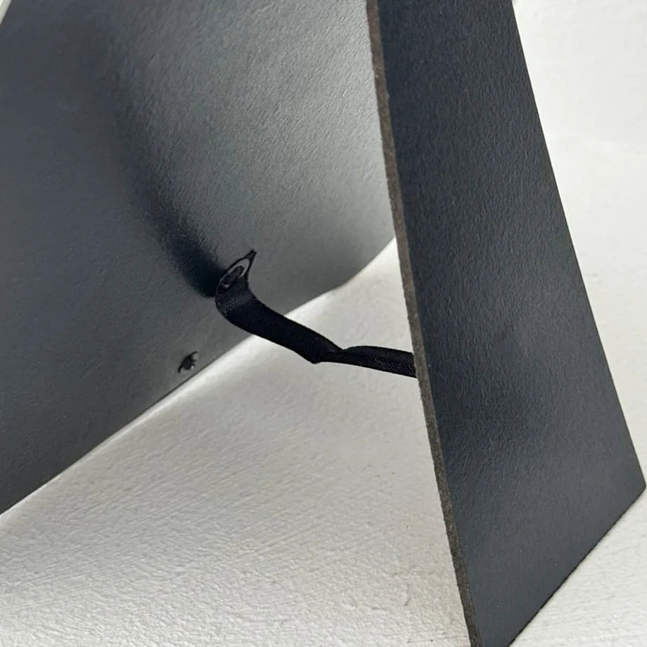 Detailed view of the black easel stand mechanism on the back of the irregular mirror - RoomDen
