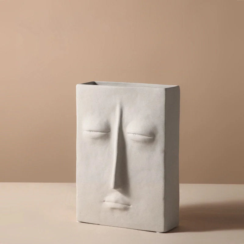 Front view of the large rectangular abstract face vase with closed eyes in frosted ceramic - RoomDen.