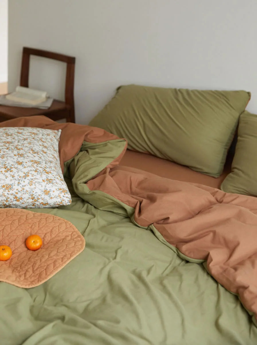 Detail of Soft Knit Jersey Fabric in Olive Green with Floral Pillow Accent - RoomDen
