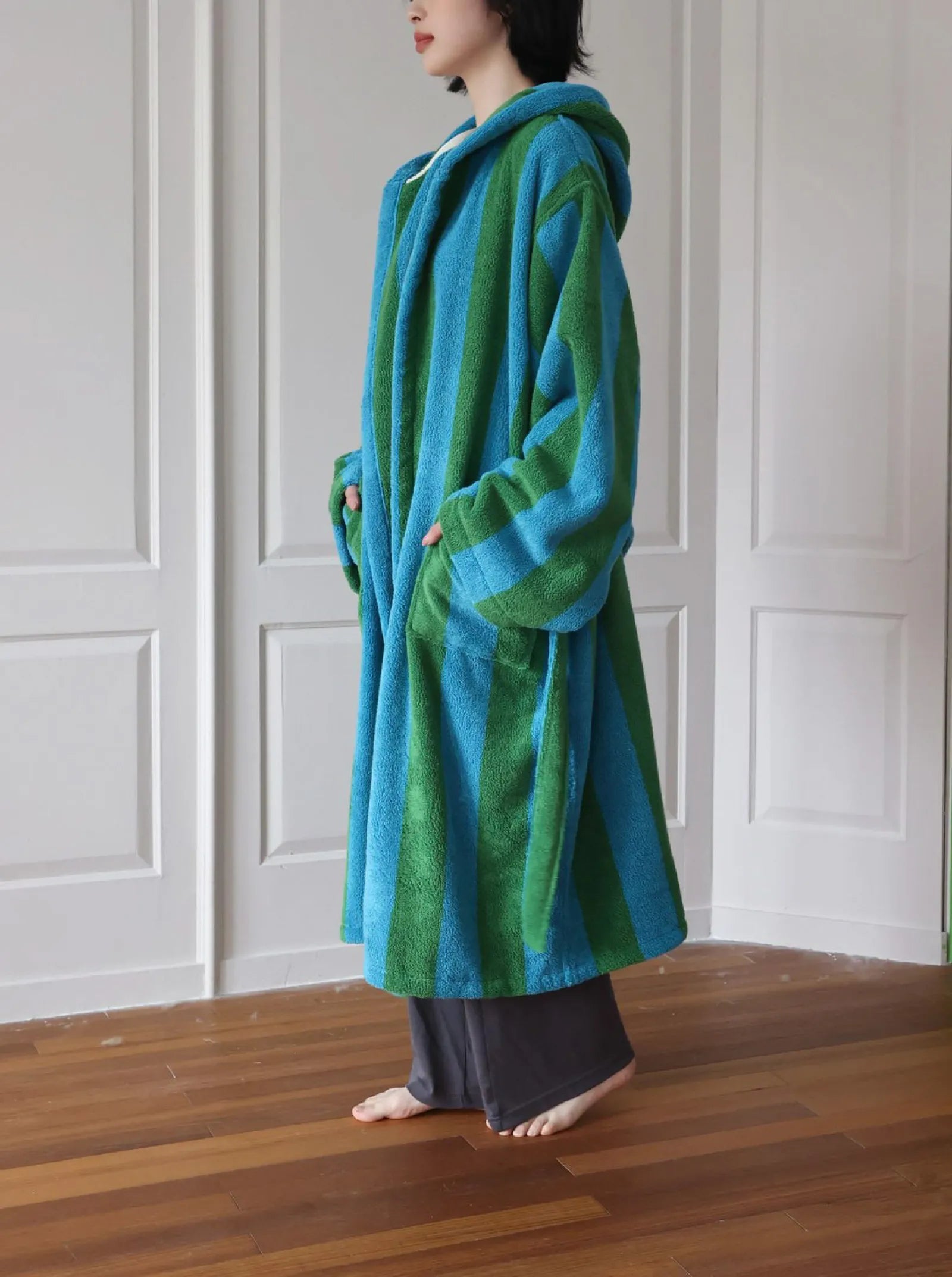 Side view showing the deep pockets on the green and blue striped bathrobe - RoomDen