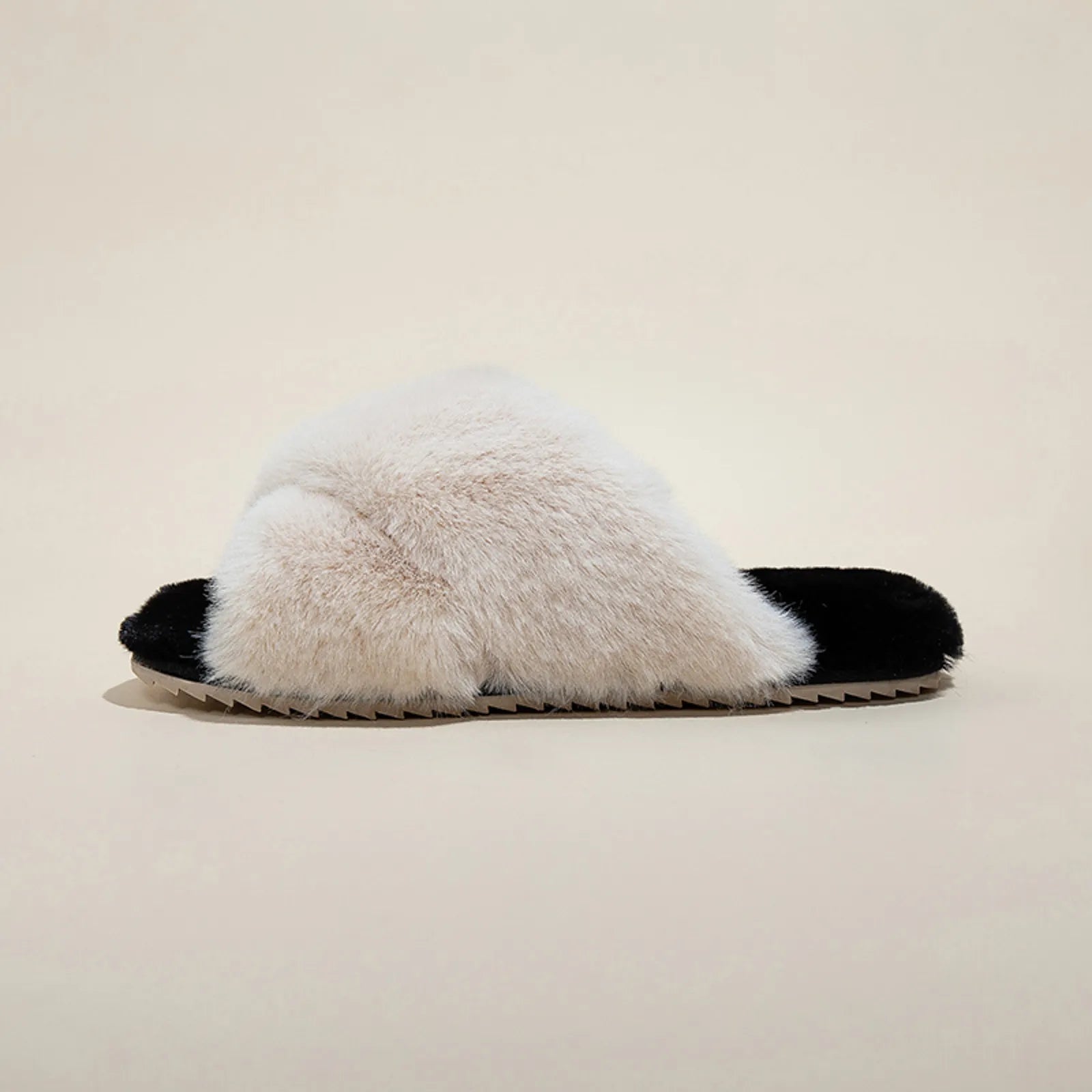 Side profile of a single White and Black faux fur slipper showing sole thickness - RoomDen