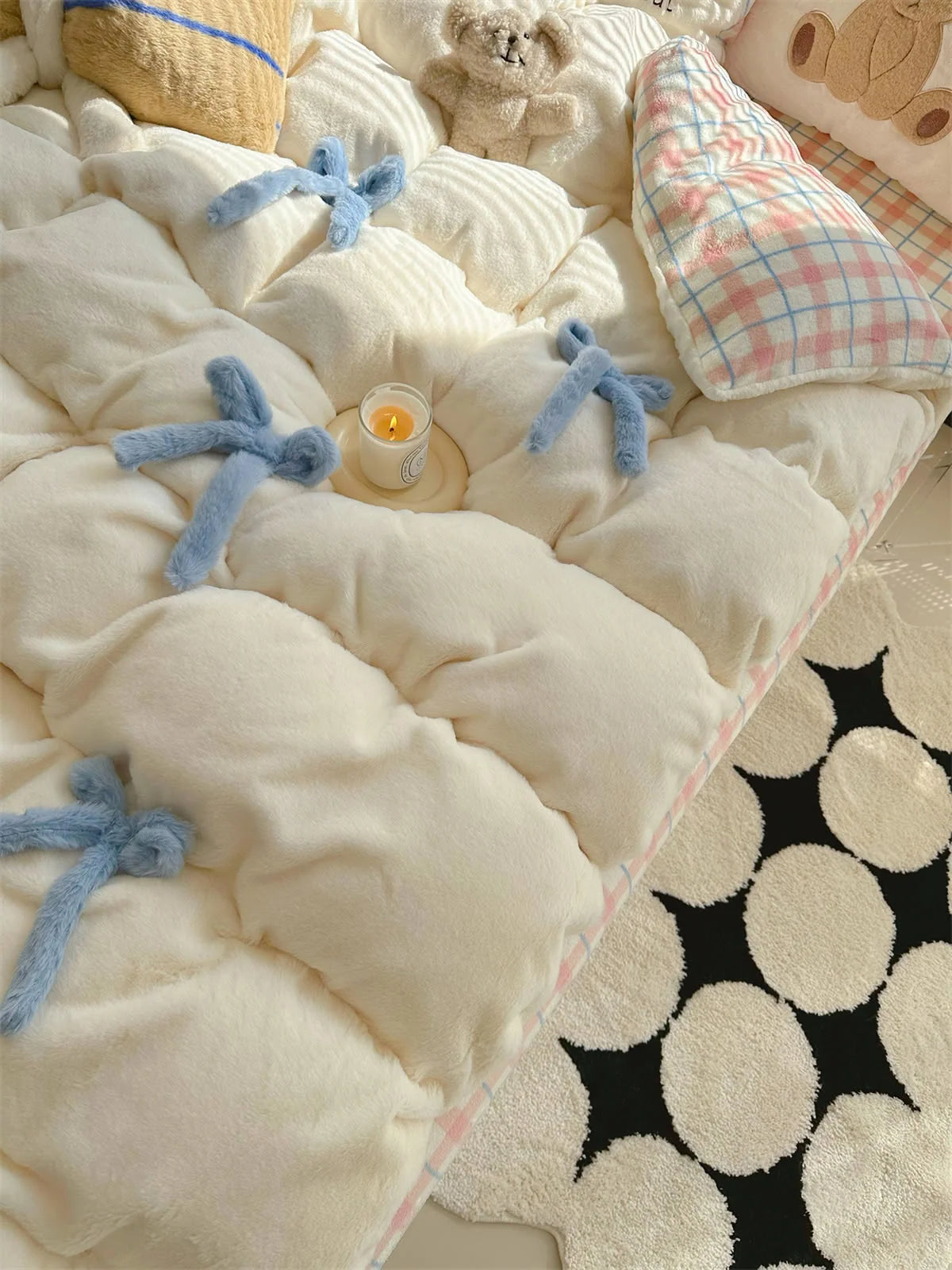 Top-down view of the creamy white tufted comforter with blue bowknots. - RoomDen