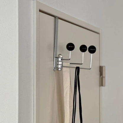 Side profile of the black metal over-the-door hook, showing how it fits over the door frame - RoomDen