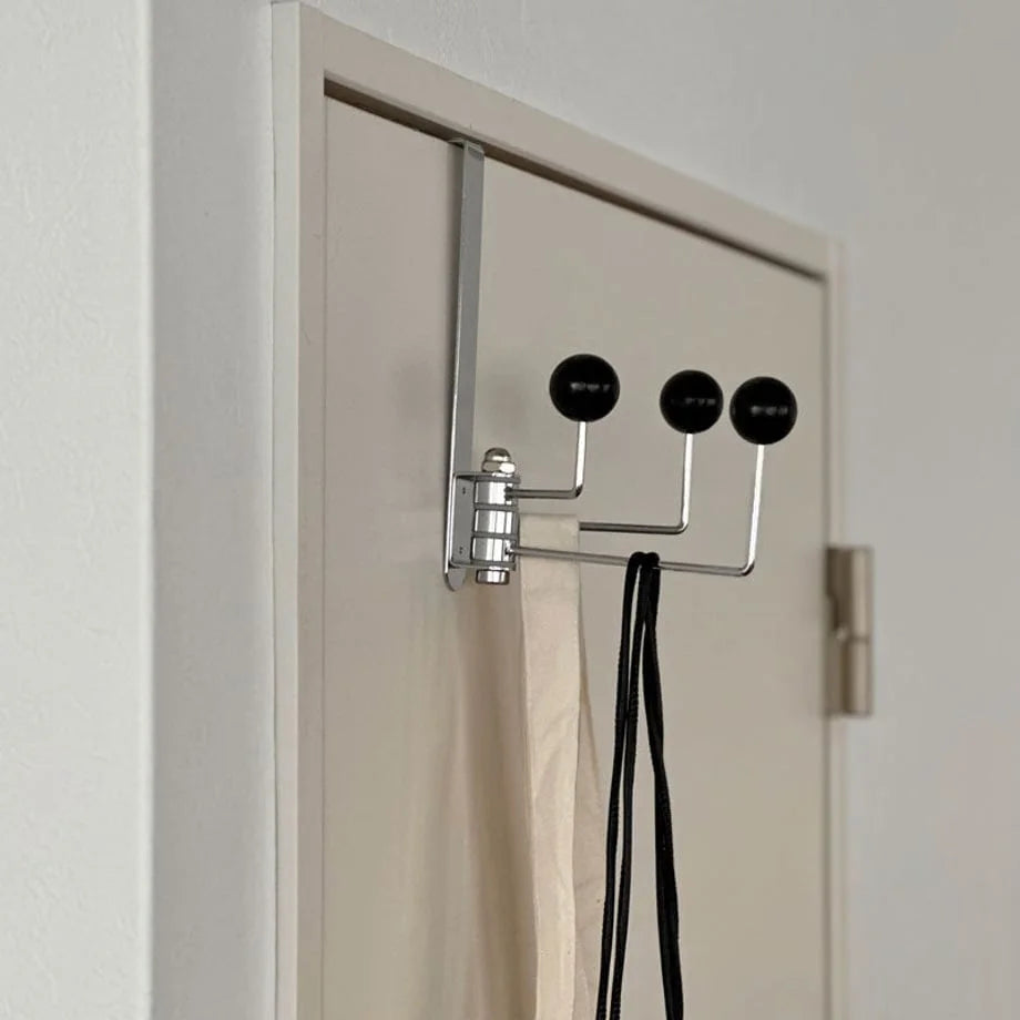 Side profile of the black metal over-the-door hook, showing how it fits over the door frame - RoomDen