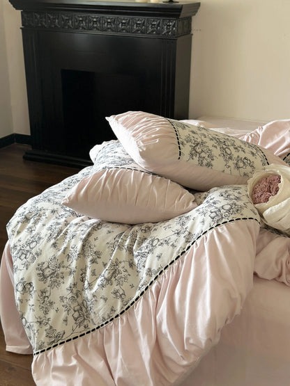 Another angle of the Pink Toile bedding set, showing the contrast with the dark floor and fireplace. - RoomDen
