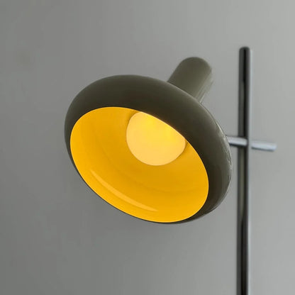 Close-up of the lamp head illuminated with a warm, yellow-toned light.