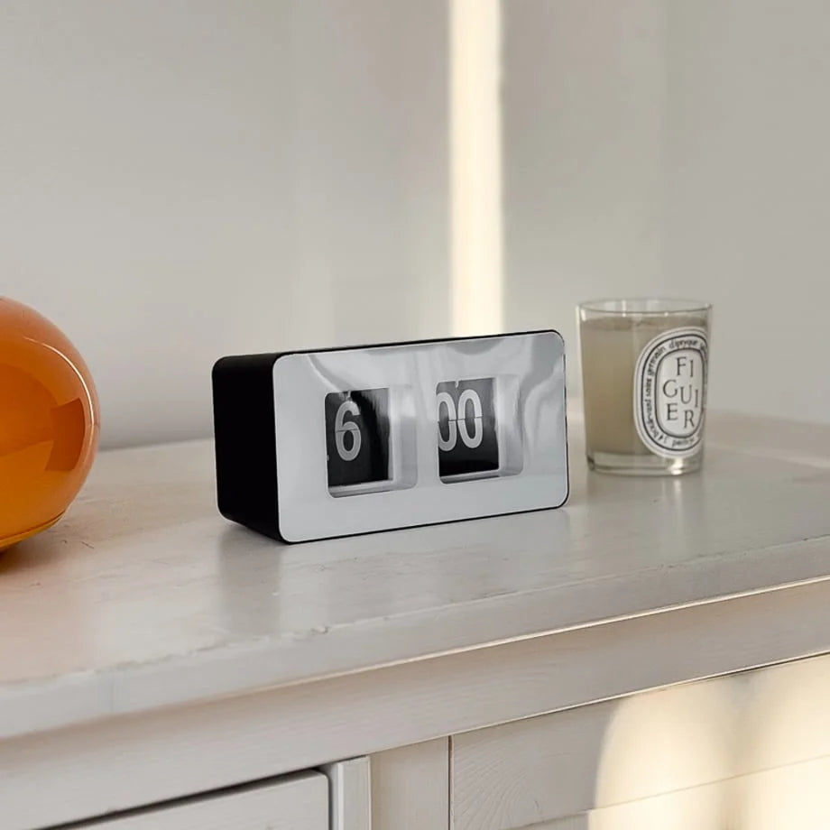 Side view of the black and white minimalist table clock in a brightly lit room. - RoomDen